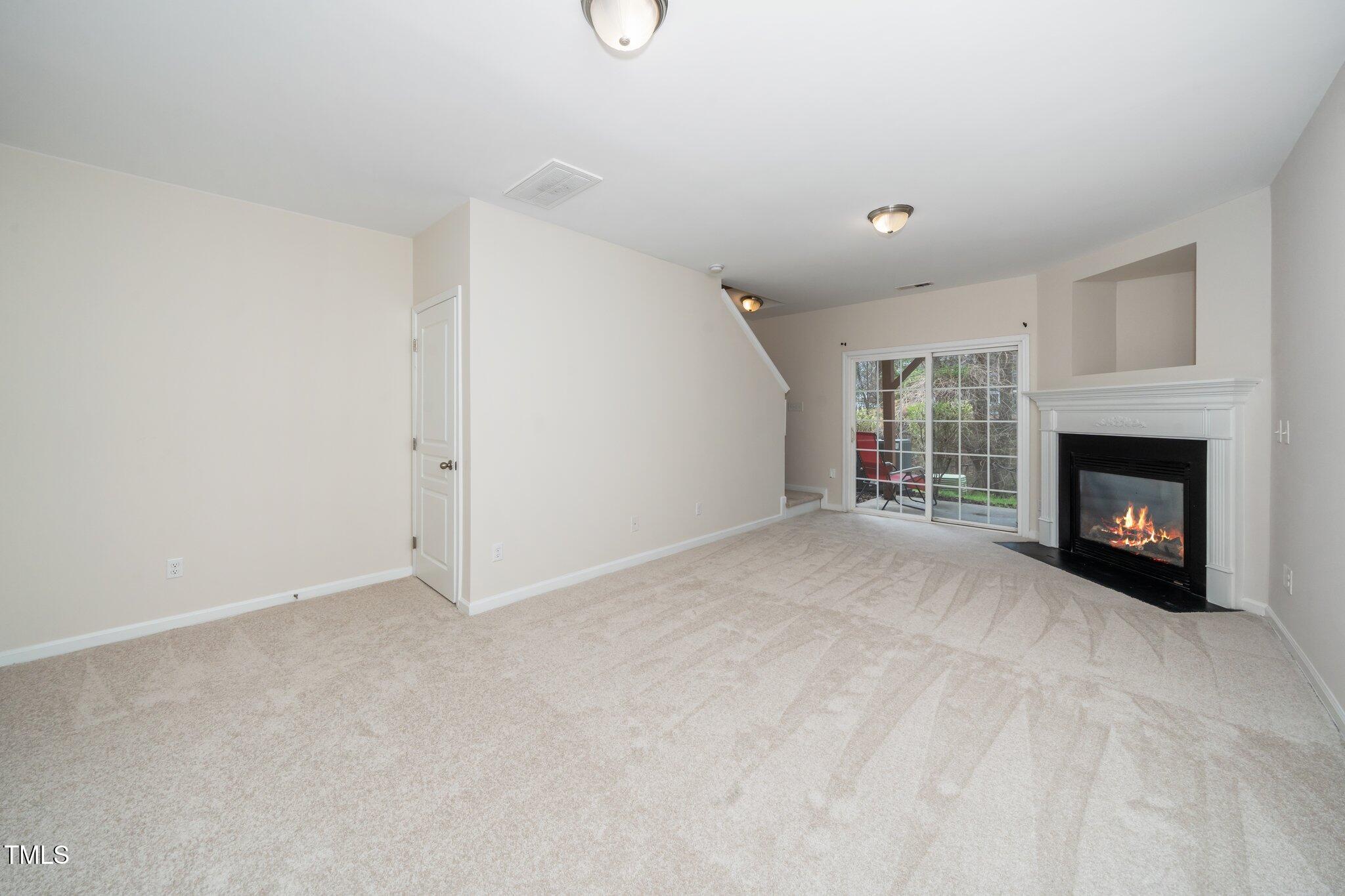 7753 Winners Edge Street Raleigh, NC 27617 - Photo 33 of 46 a view of an empty room with a window and fireplace