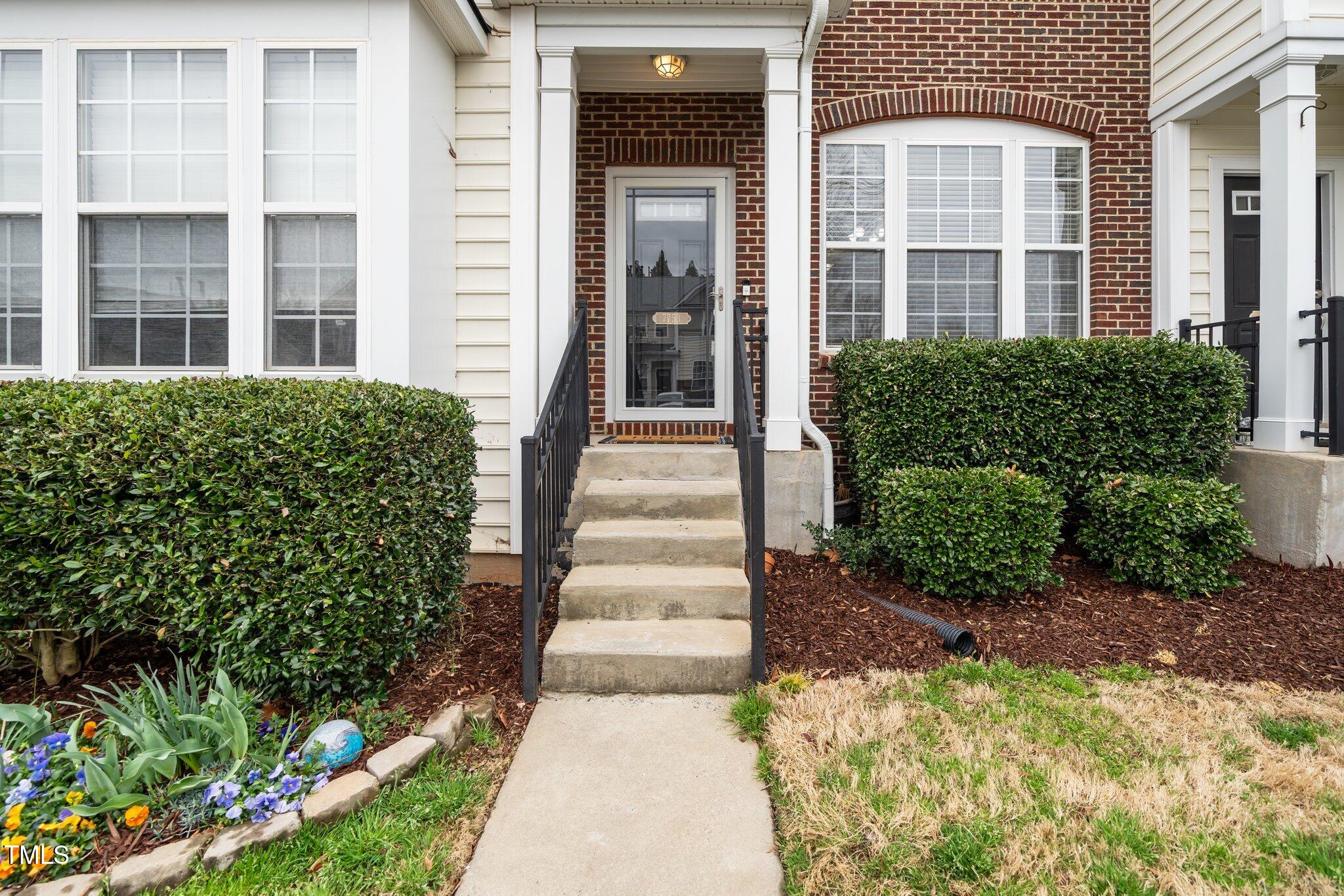 7753 Winners Edge Street Raleigh, NC 27617 - Photo 3 of 46 a front view of a building with a garden