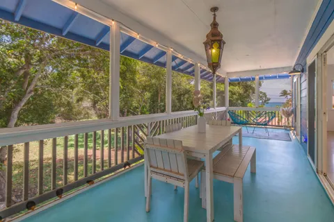 a view of a glass door with a bench in balcony