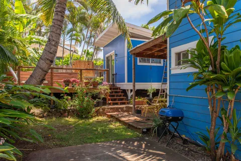 a view of a wooden bench in front of a house
