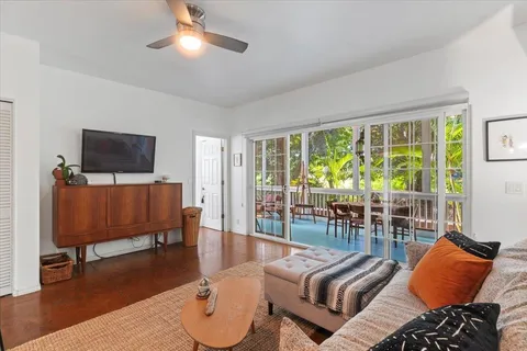 a view of a glass door with a bench in balcony