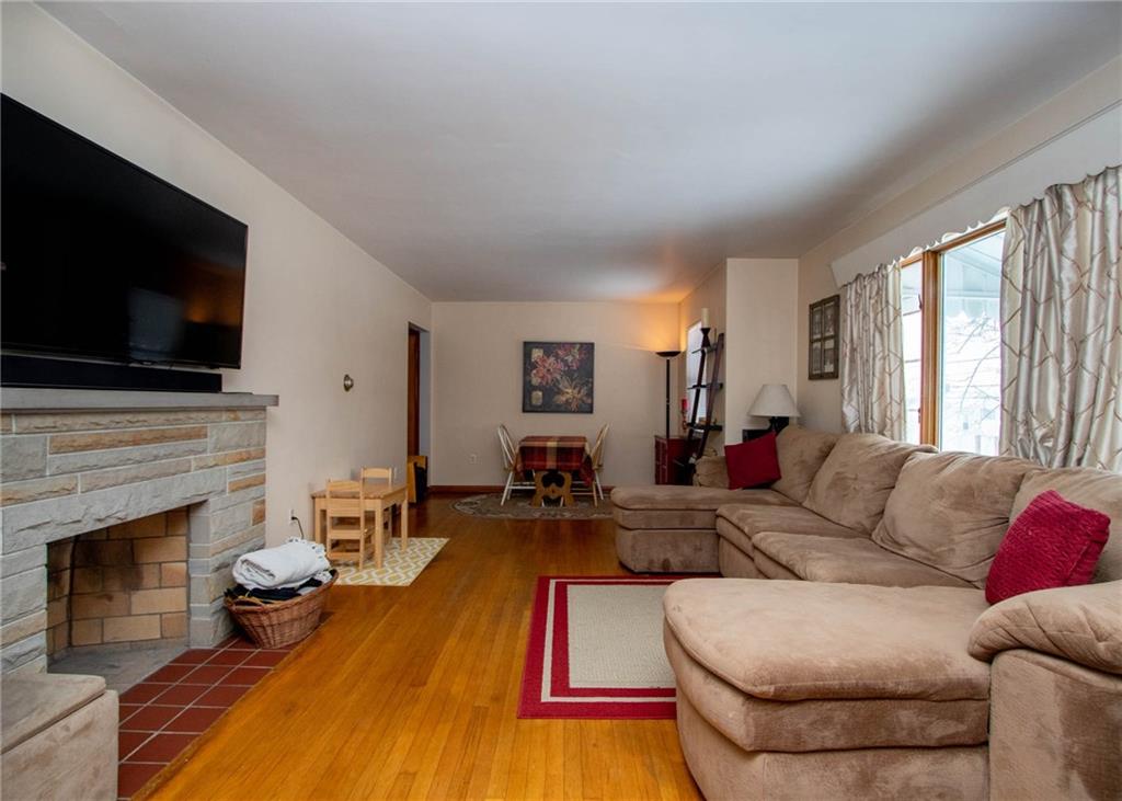 627 Virginia Avenue Rochester, PA 15074 - Photo 3 of 17 Oversized Living Room with large picture window and stone wood burning fireplace to keep you cozy on those cold winter nights