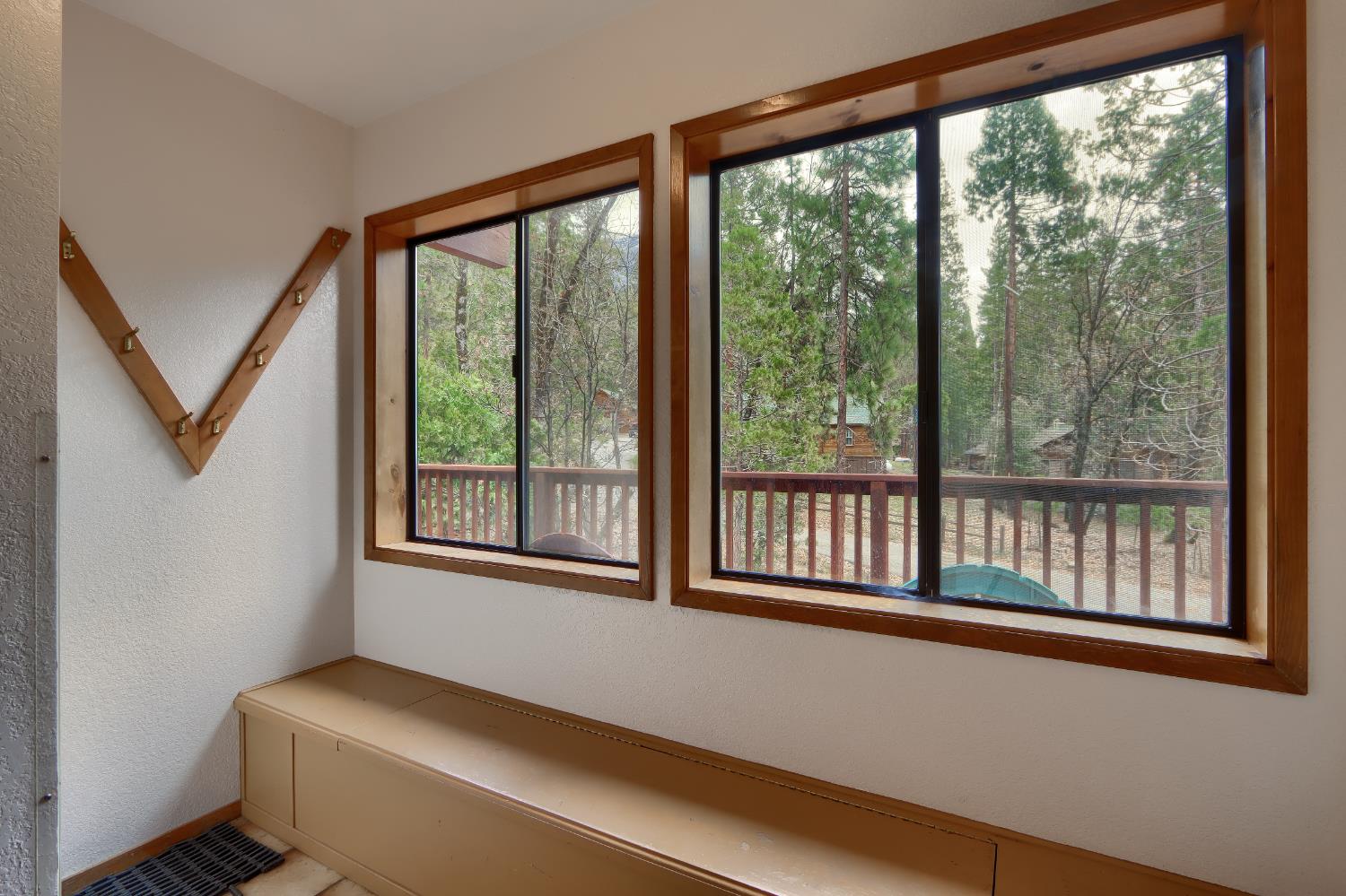 8041 Chilnualna Falls Road Wawona, CA 95389 - Photo 27 of 46 a room with a large window and a bed