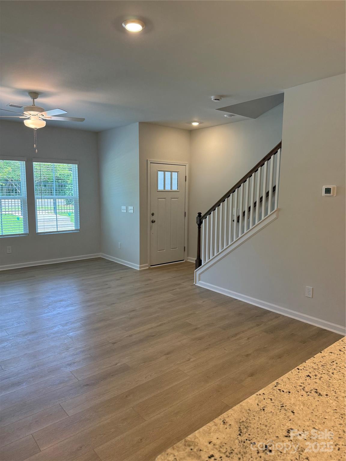 5821 Tuckaseegee Road Charlotte, NC 28208 - Photo 3 of 9 a view of an empty room with wooden floor and a window