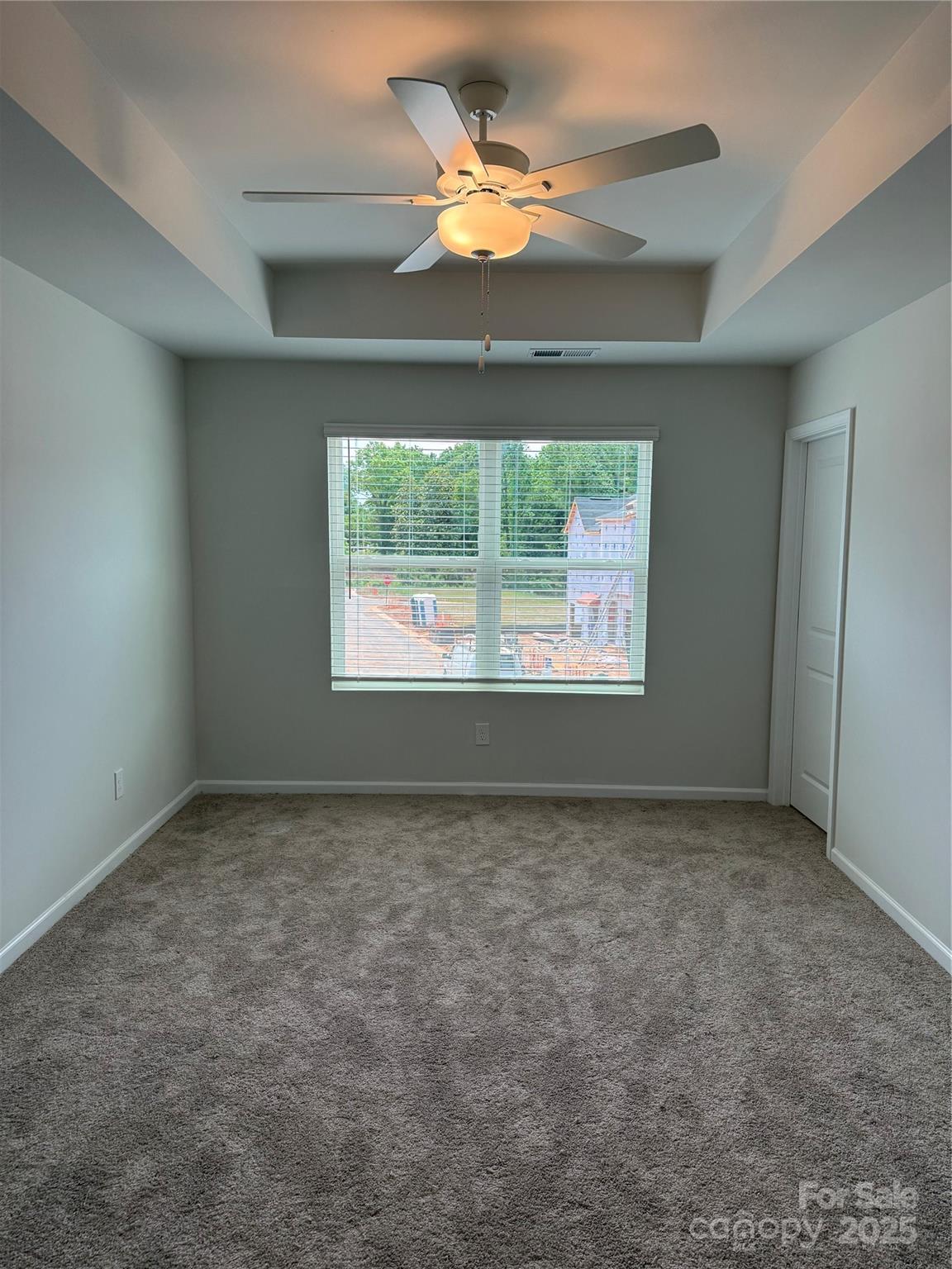 5821 Tuckaseegee Road Charlotte, NC 28208 - Photo 7 of 9 an empty room with a window and a fan