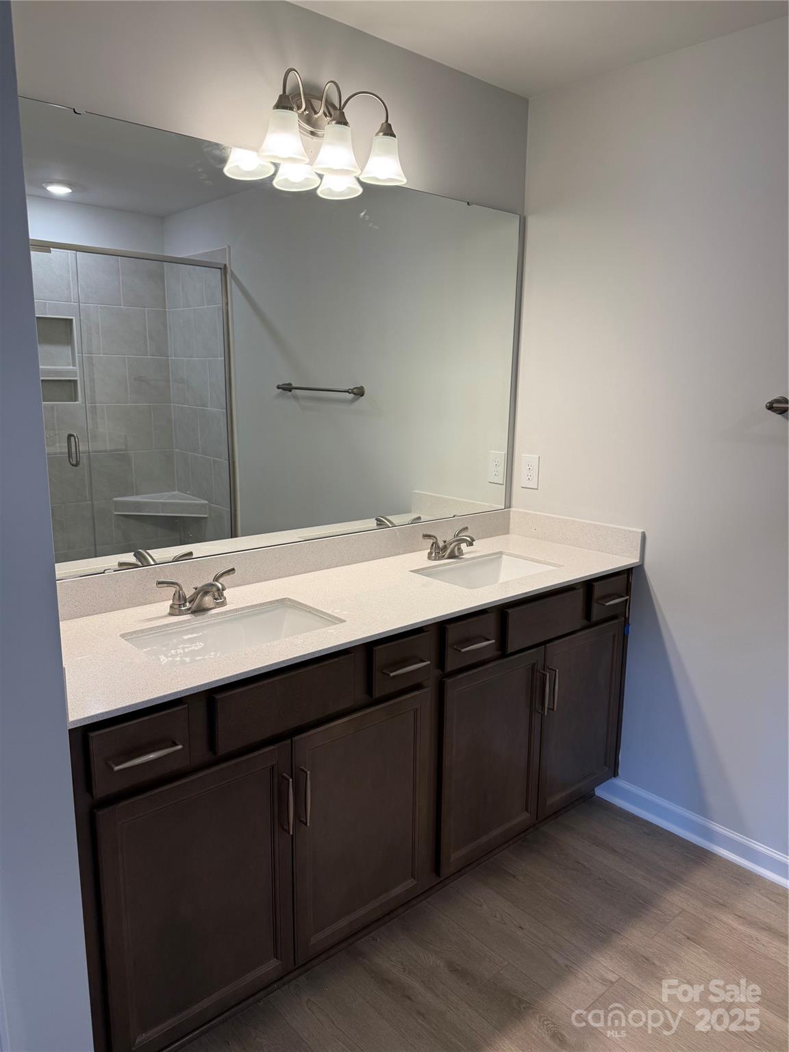 5821 Tuckaseegee Road Charlotte, NC 28208 - Photo 8 of 9 a bathroom with a double vanity sink and a mirror