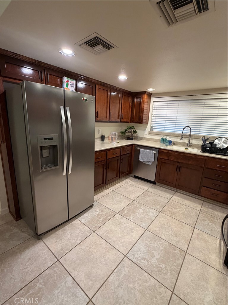 209 Kimberly Lane Ridgecrest, CA 93555 - Photo 17 of 62 a kitchen with stainless steel appliances granite countertop a refrigerator a sink a stove a microwave and island