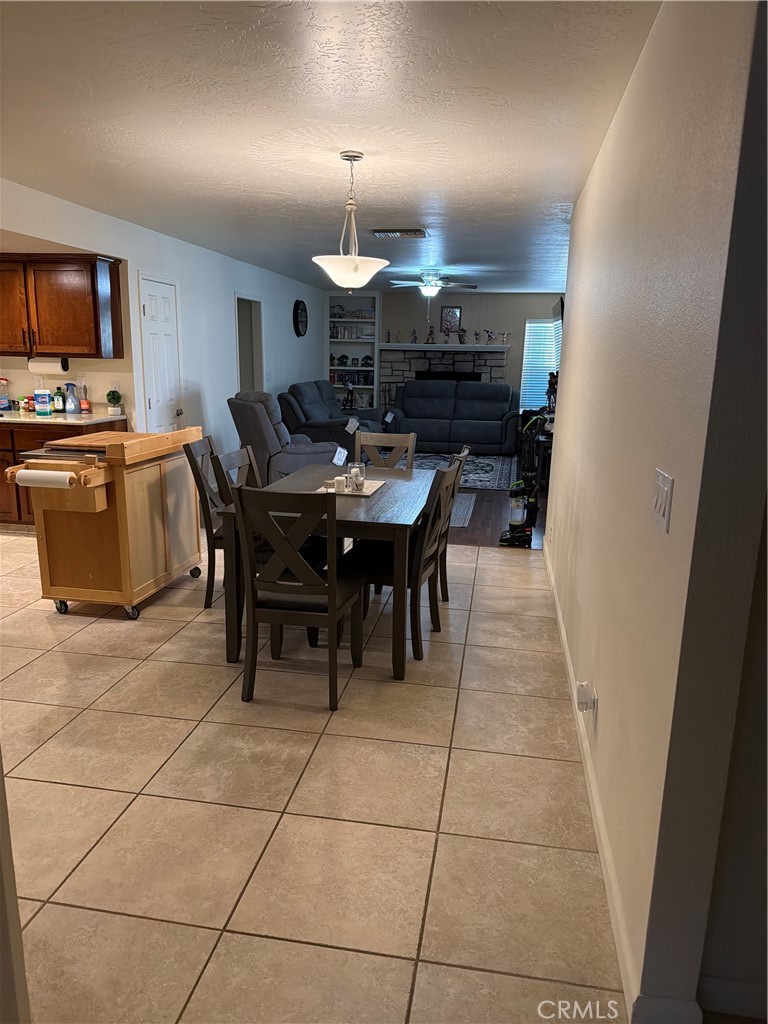 209 Kimberly Lane Ridgecrest, CA 93555 - Photo 22 of 62 a large dining hall with stainless steel appliances a stove a sink dishwasher and a dining table with wooden floor