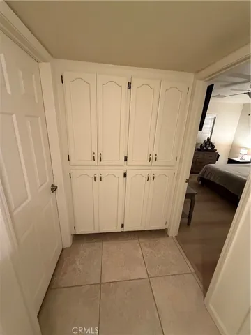 a bathroom with a toilet a sink a rug and mirror