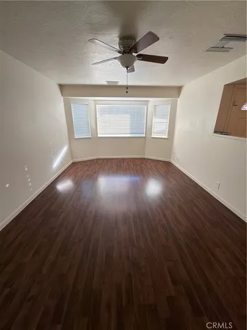 a view of workspace with wooden floor windows