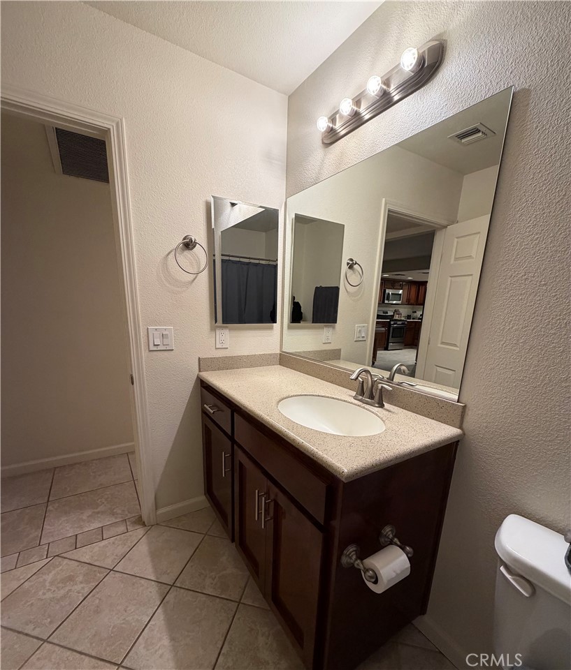 209 Kimberly Lane Ridgecrest, CA 93555 - Photo 42 of 62 a bathroom with a sink and a mirror