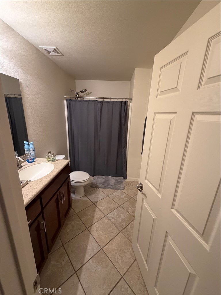 209 Kimberly Lane Ridgecrest, CA 93555 - Photo 44 of 62 a bathroom with a granite countertop sink toilet and shower