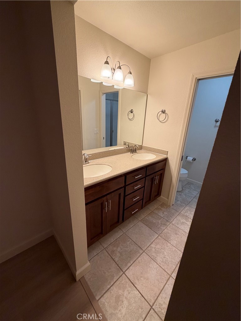 209 Kimberly Lane Ridgecrest, CA 93555 - Photo 48 of 62 a spacious bathroom with a double vanity sink and a mirror