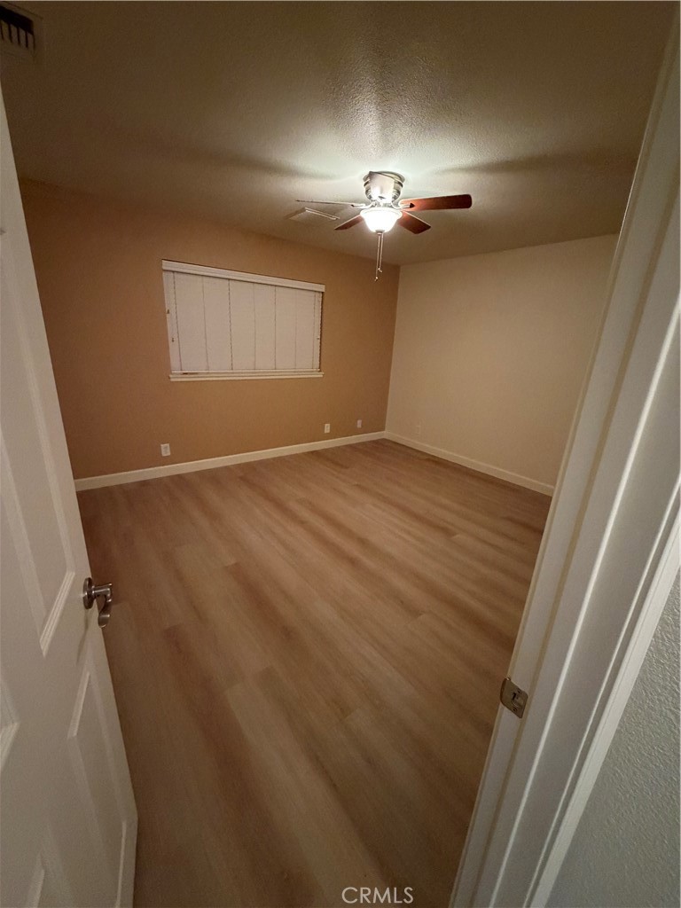 209 Kimberly Lane Ridgecrest, CA 93555 - Photo 52 of 62 wooden floor in an empty room with a mirror