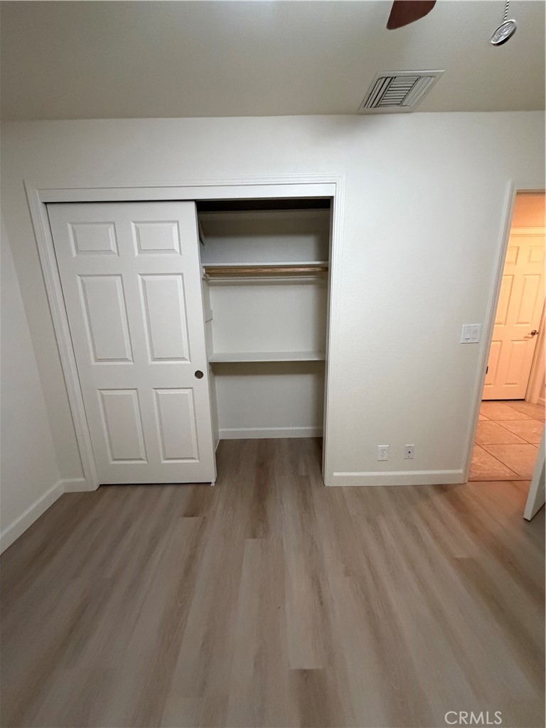 209 Kimberly Lane Ridgecrest, CA 93555 - Photo 55 of 62 an empty room with wooden floor closet and windows