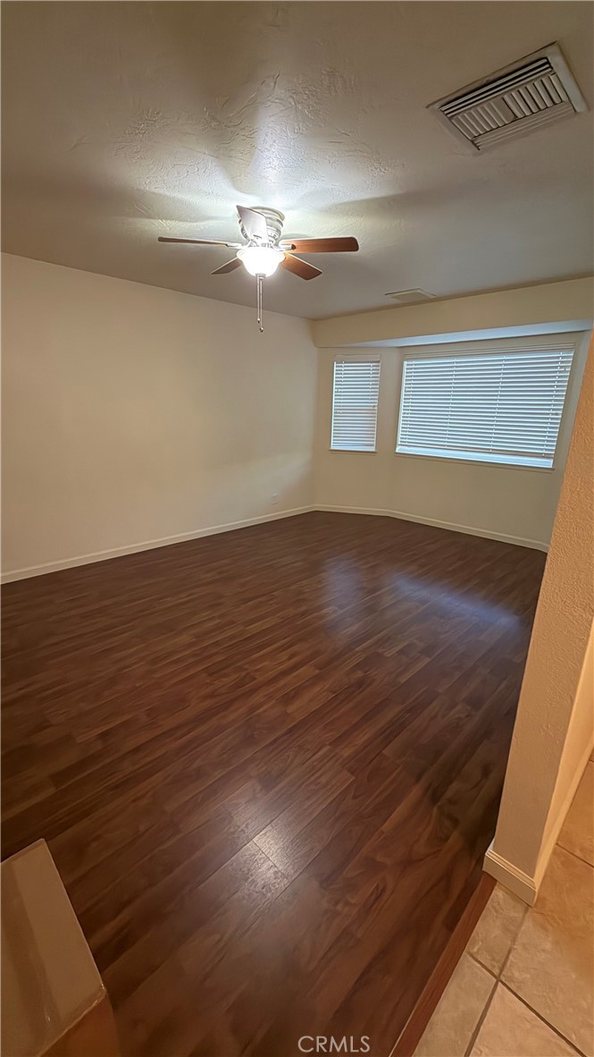 209 Kimberly Lane Ridgecrest, CA 93555 - Photo 58 of 62 a view of an empty room with wooden floor and a window