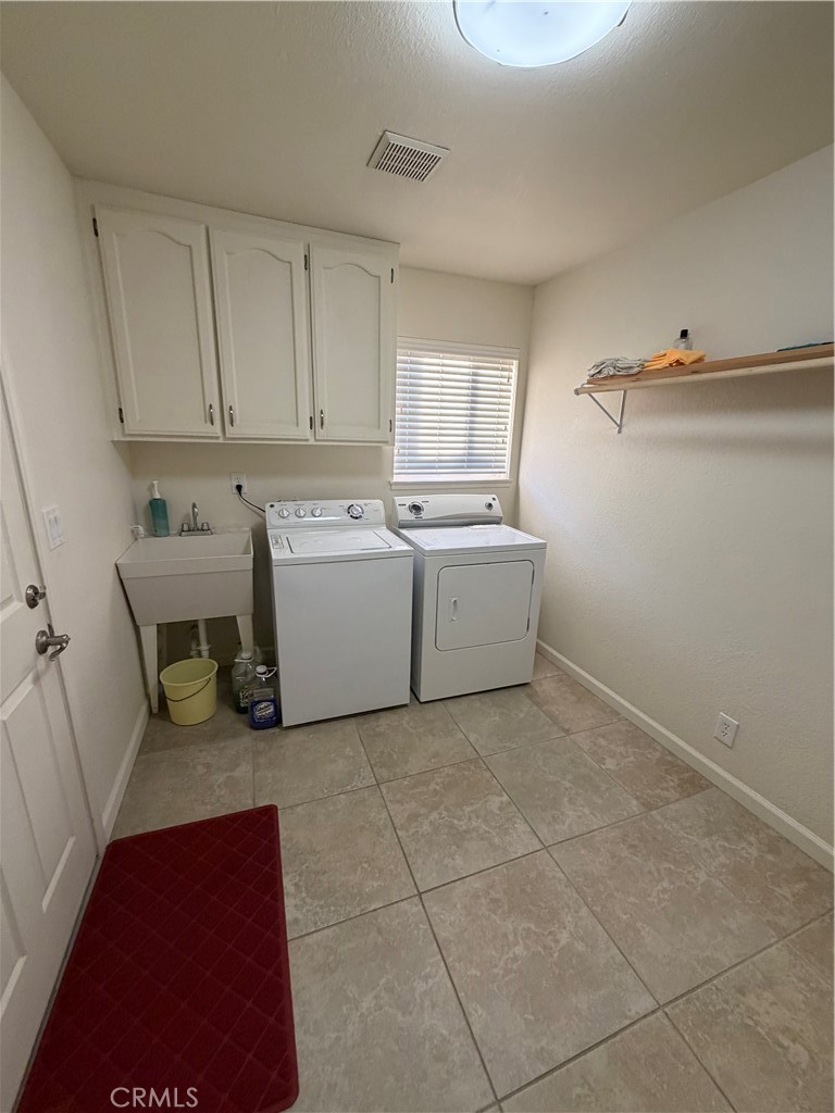 209 Kimberly Lane Ridgecrest, CA 93555 - Photo 59 of 62 a room with a cabinets and window