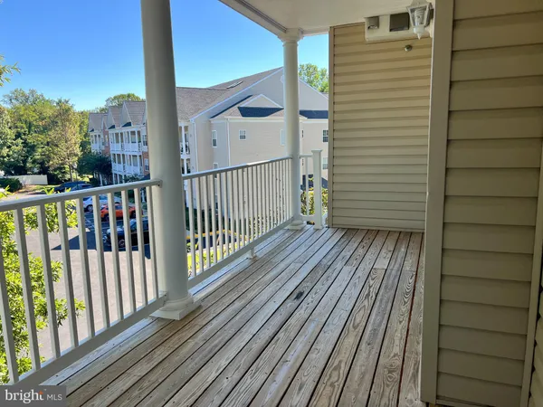 a view of a balcony with wooden floor