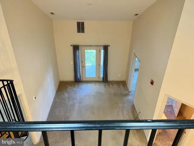 a view of a hallway with entryway wooden floor and front door