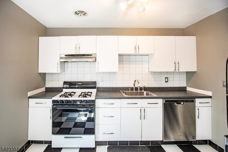 1130 Valley Road, Unit 2B Wayne, NJ 07470 - Photo 17 of 47 a kitchen with cabinets appliances and a sink
