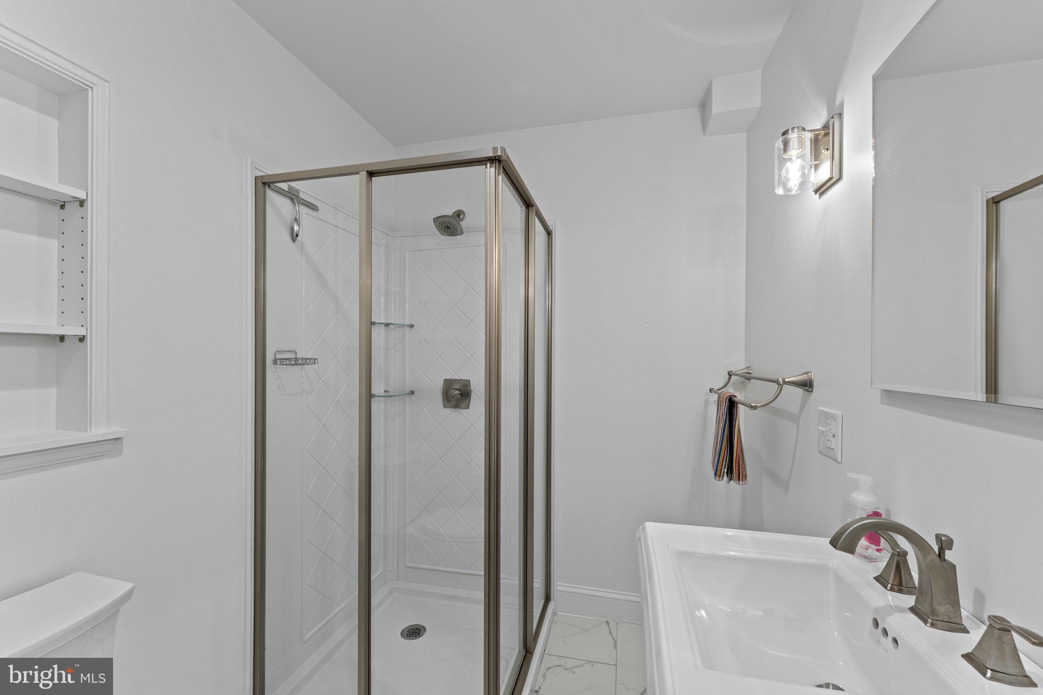 216 Walnut Street Berryville, VA 22611 - Photo 13 of 36 a bathroom with a sink and shower