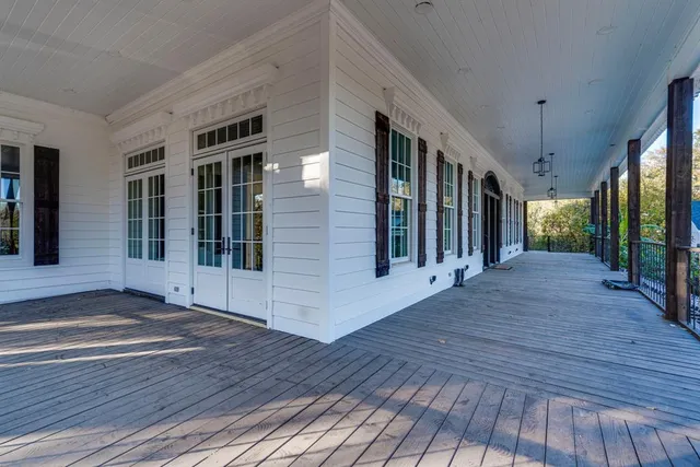 a view of a porch with wooden floor and stairs