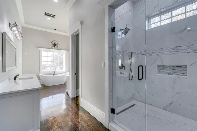 a en suite bathroom with a granite countertop shower