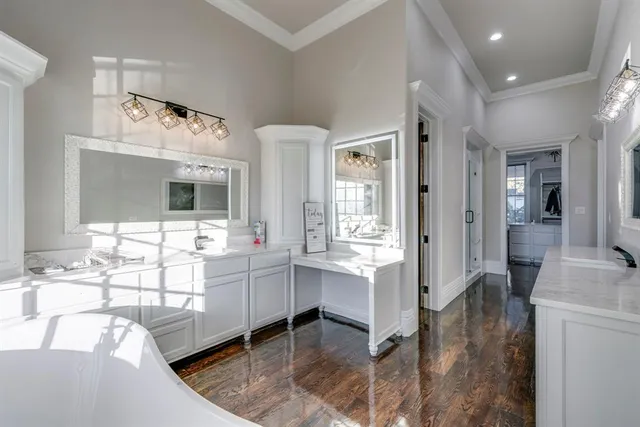 a en suite bathroom with a double vanity sink a mirror and shower