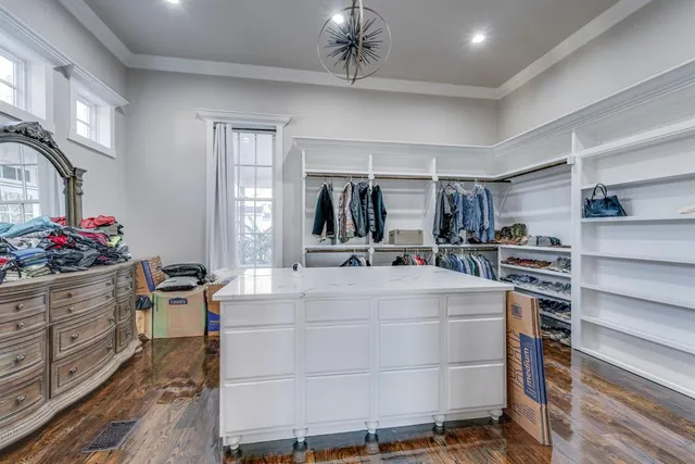 a kitchen with kitchen island a counter top space a sink stainless steel appliances and cabinets