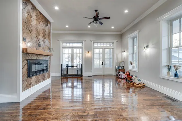 a view of a room with wooden floor and windows