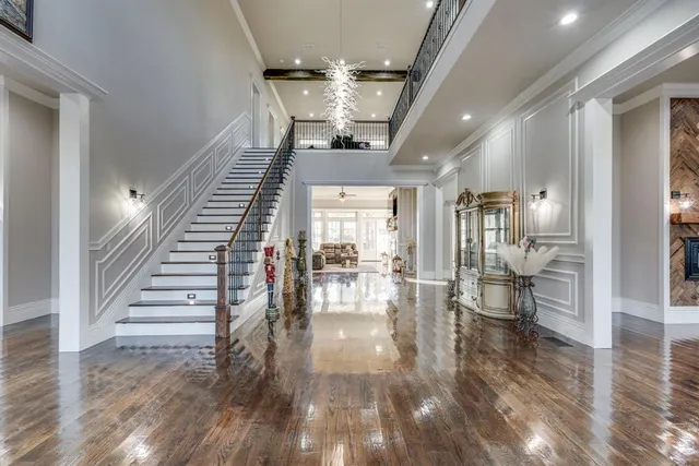 a view of entryway and hall with wooden floor