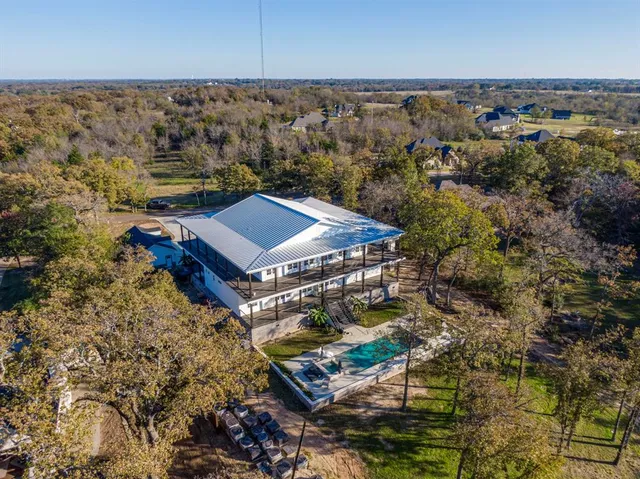an aerial view of houses with yard