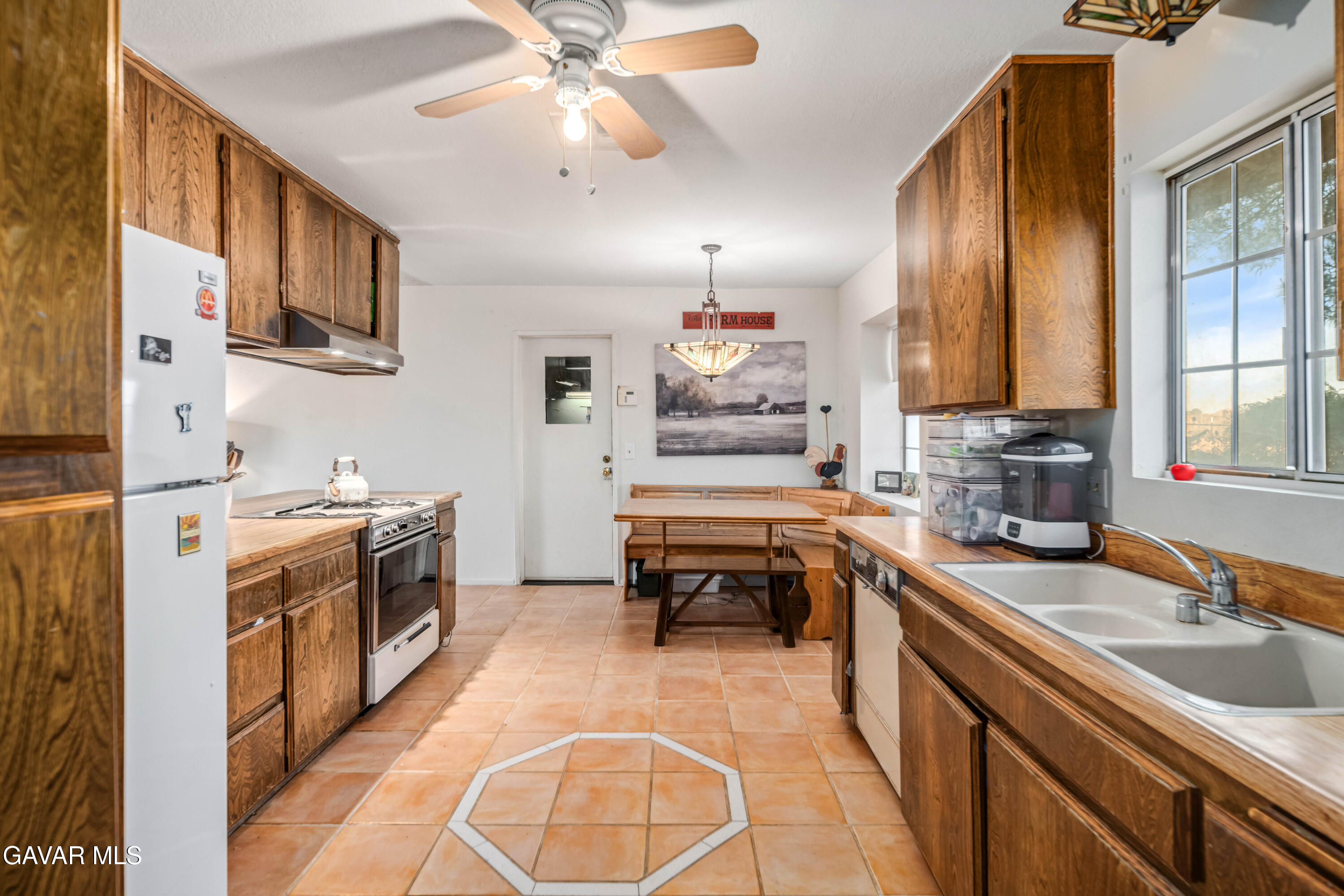 20539 East Ave R Palmdale, CA 93591 - Photo 25 of 55 a kitchen that has a lot of cabinets in it and wooden floors