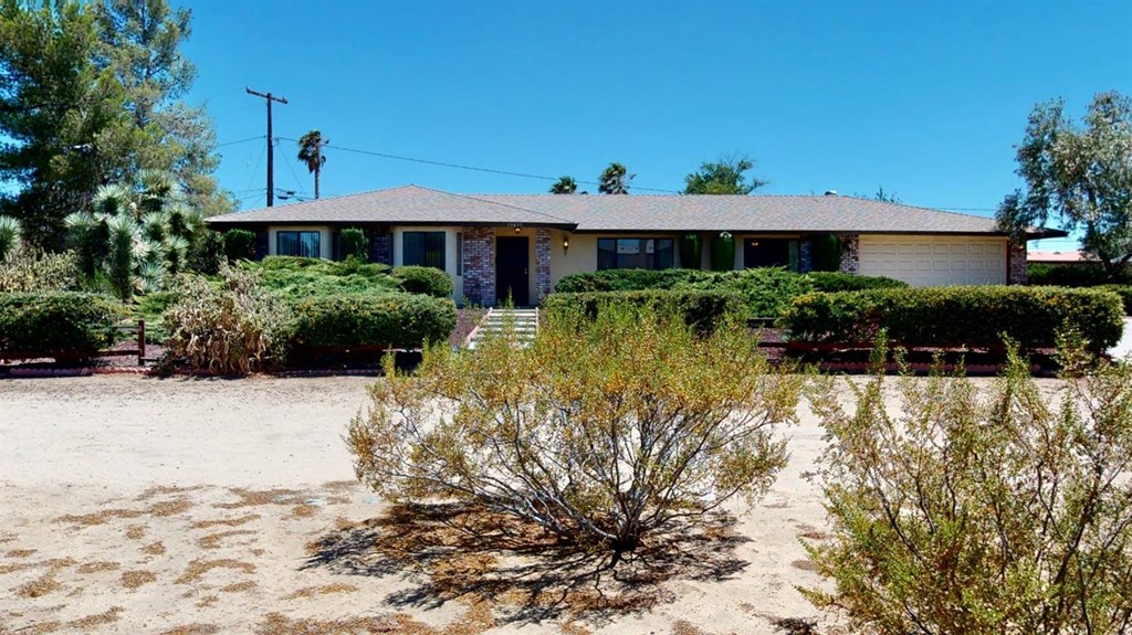 19435 Red Feather Road Apple Valley, CA 92307 - Photo 1 of 1 a front view of a house with a yard