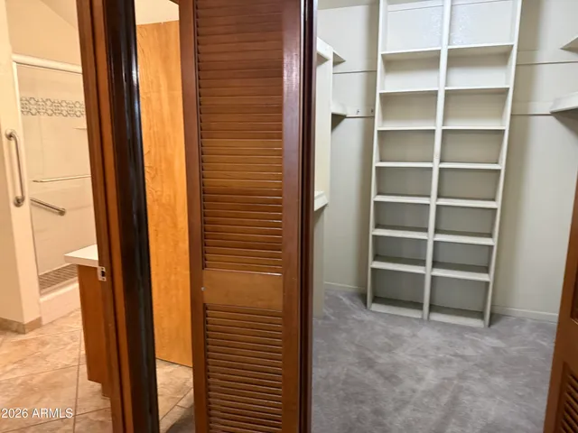 a view of an empty room with a white cabinet and a window