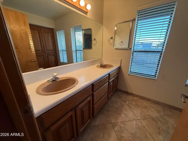 a bathroom with a granite countertop toilet and a shower