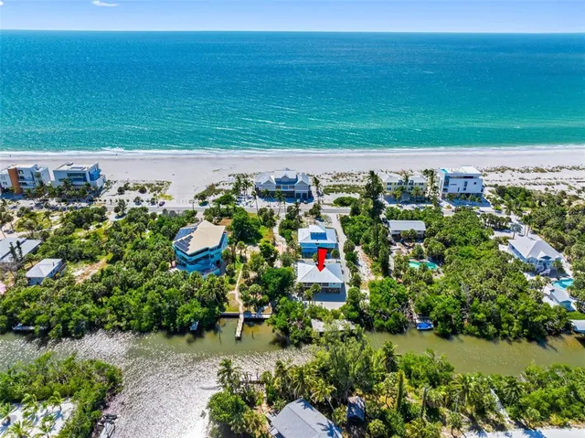 a kitchen with white cabinets and sink