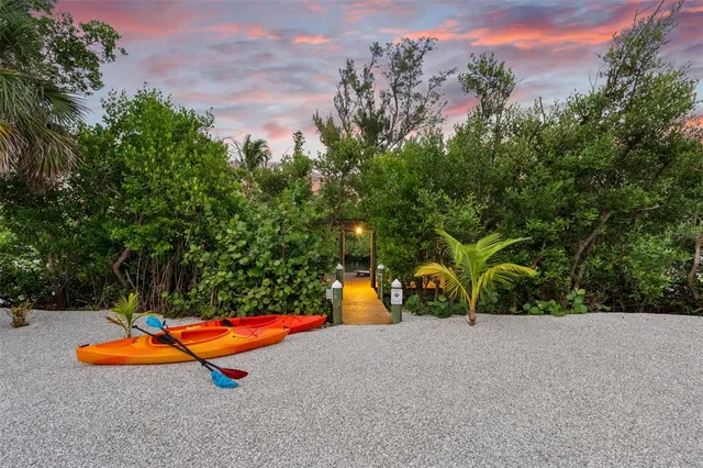 a view of a kitchen with stainless steel appliances kitchen island granite countertop a refrigerator and a stove top oven