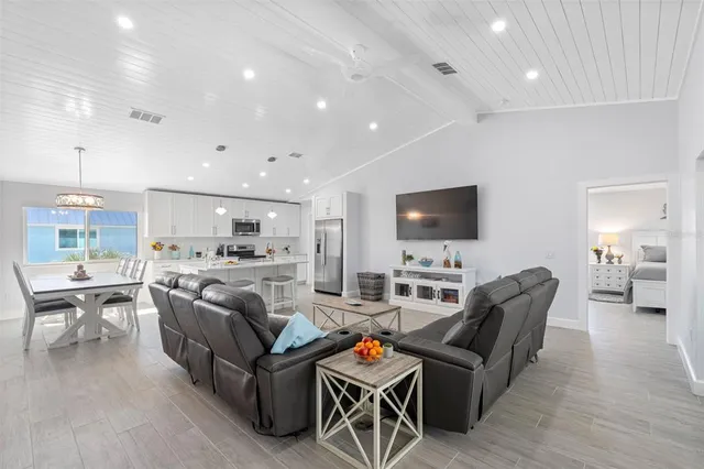 a view of a dining room with furniture wooden floor and a chandelier