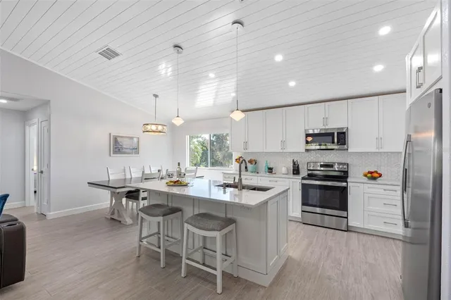 a spacious bedroom with a bed and a flat screen tv