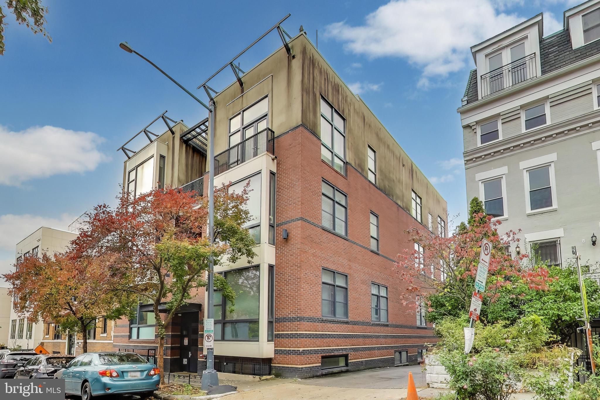 2426 Ontario Road Northwest, Unit 101 Washington, DC 20009 - Photo 1 of 22 a city street lined with buildings and cars