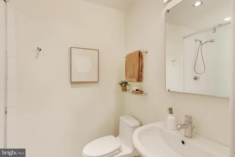 a bathroom with a toilet sink and shower