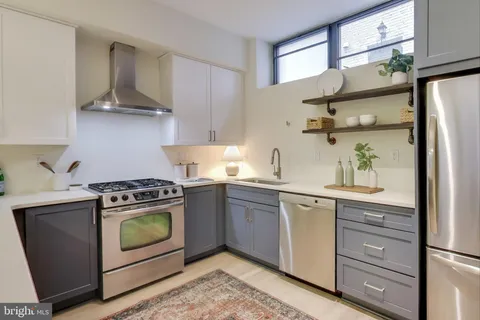a kitchen with stainless steel appliances granite countertop a stove and a refrigerator
