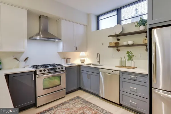 a kitchen with stainless steel appliances granite countertop a stove and a refrigerator