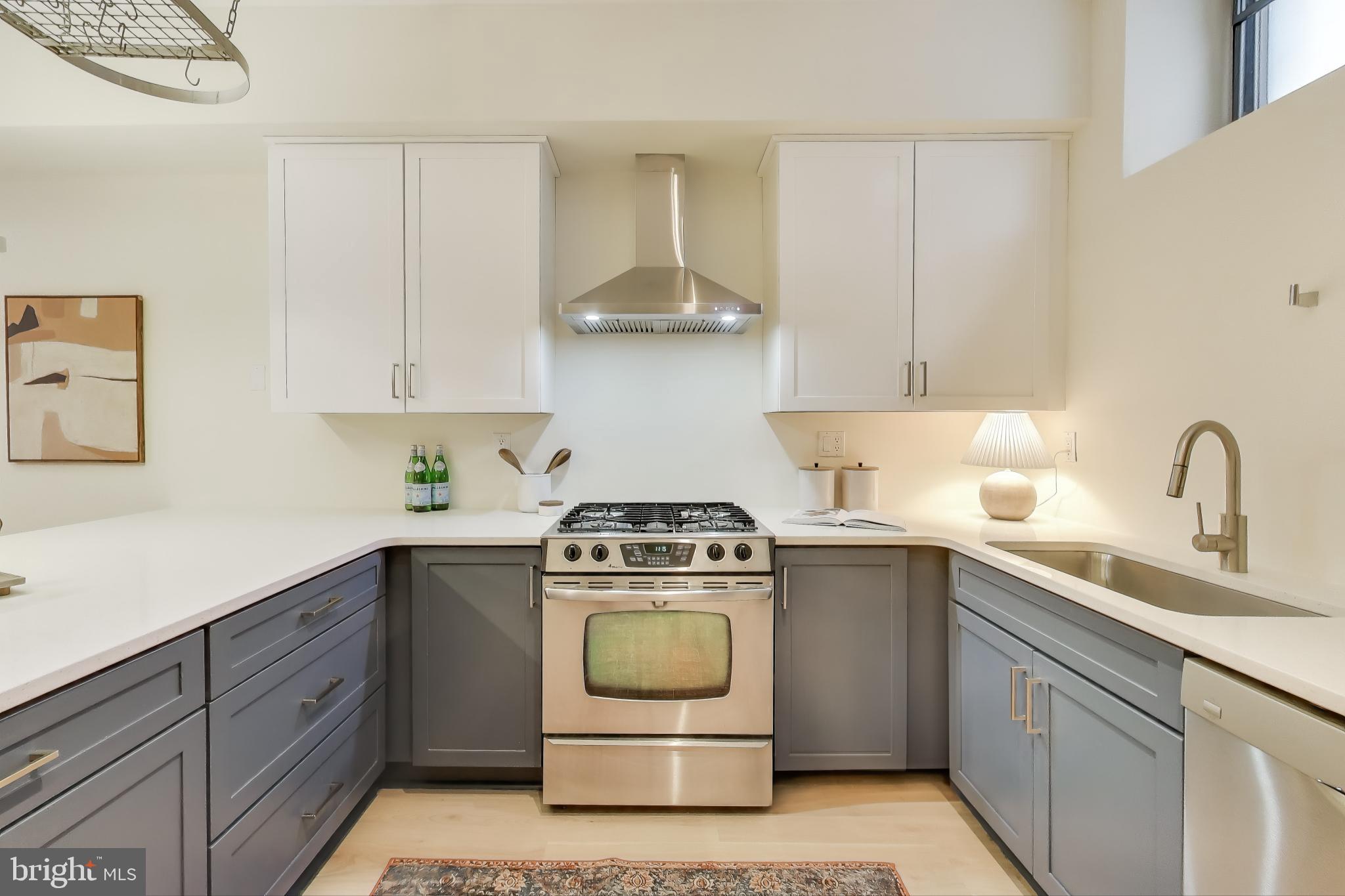 2426 Ontario Road Northwest, Unit 101 Washington, DC 20009 - Photo 8 of 22 a kitchen with a stove sink and cabinets