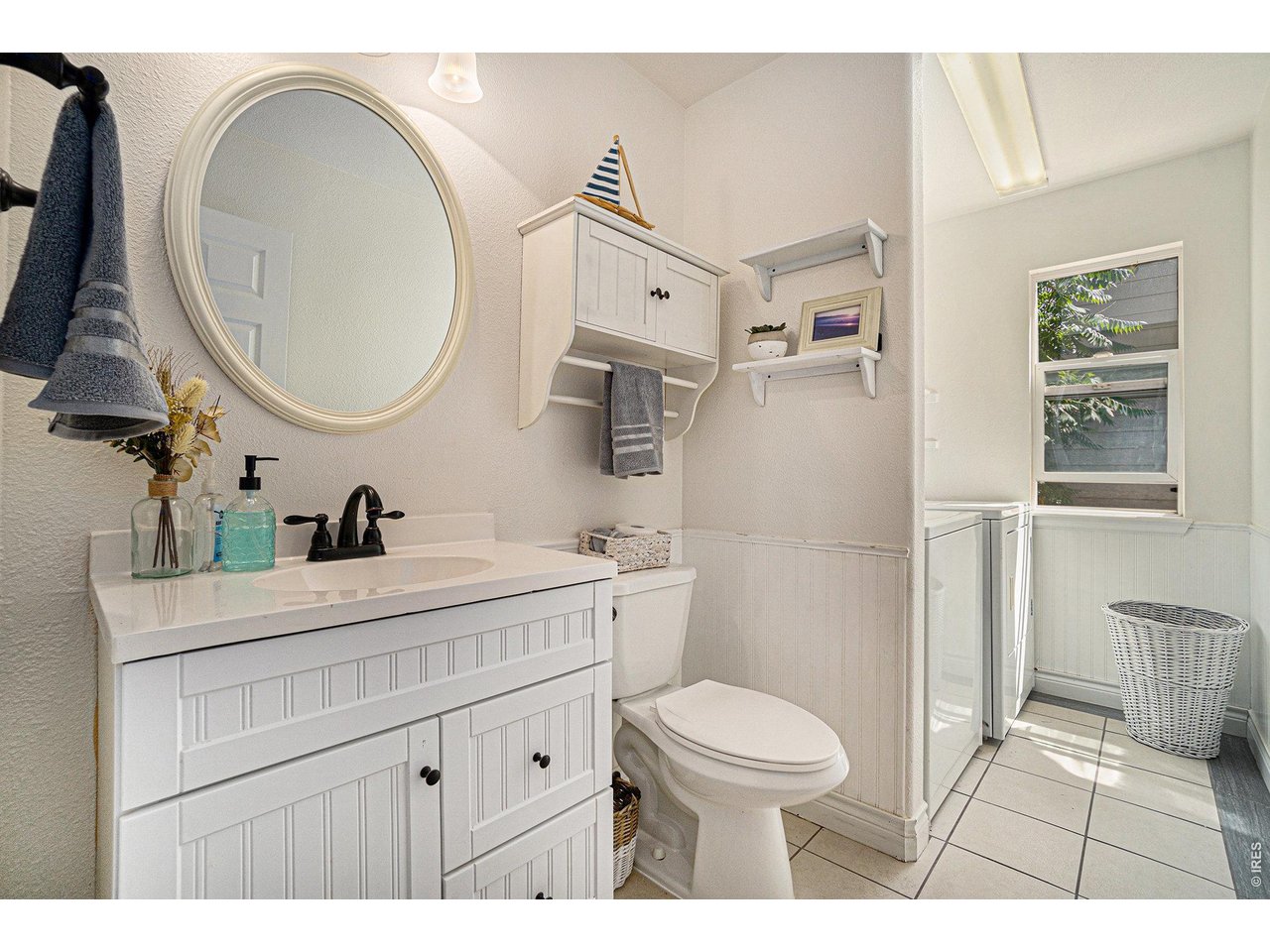 11226 Dover Street Firestone, CO 80504 - Photo 11 of 27 a bathroom with a toilet a sink a mirror and vanity