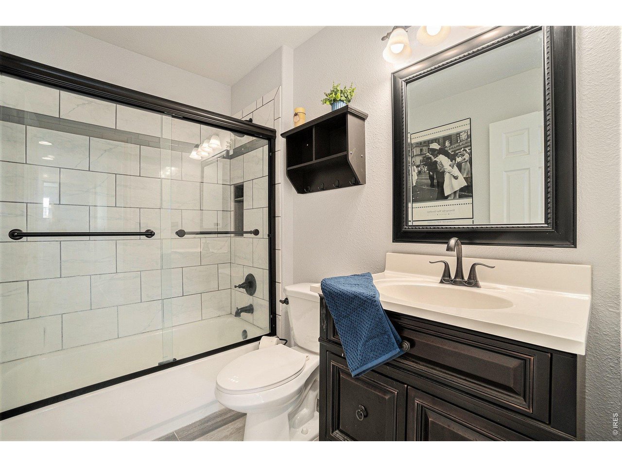 11226 Dover Street Firestone, CO 80504 - Photo 13 of 27 a bathroom with a sink a toilet a mirror and shower