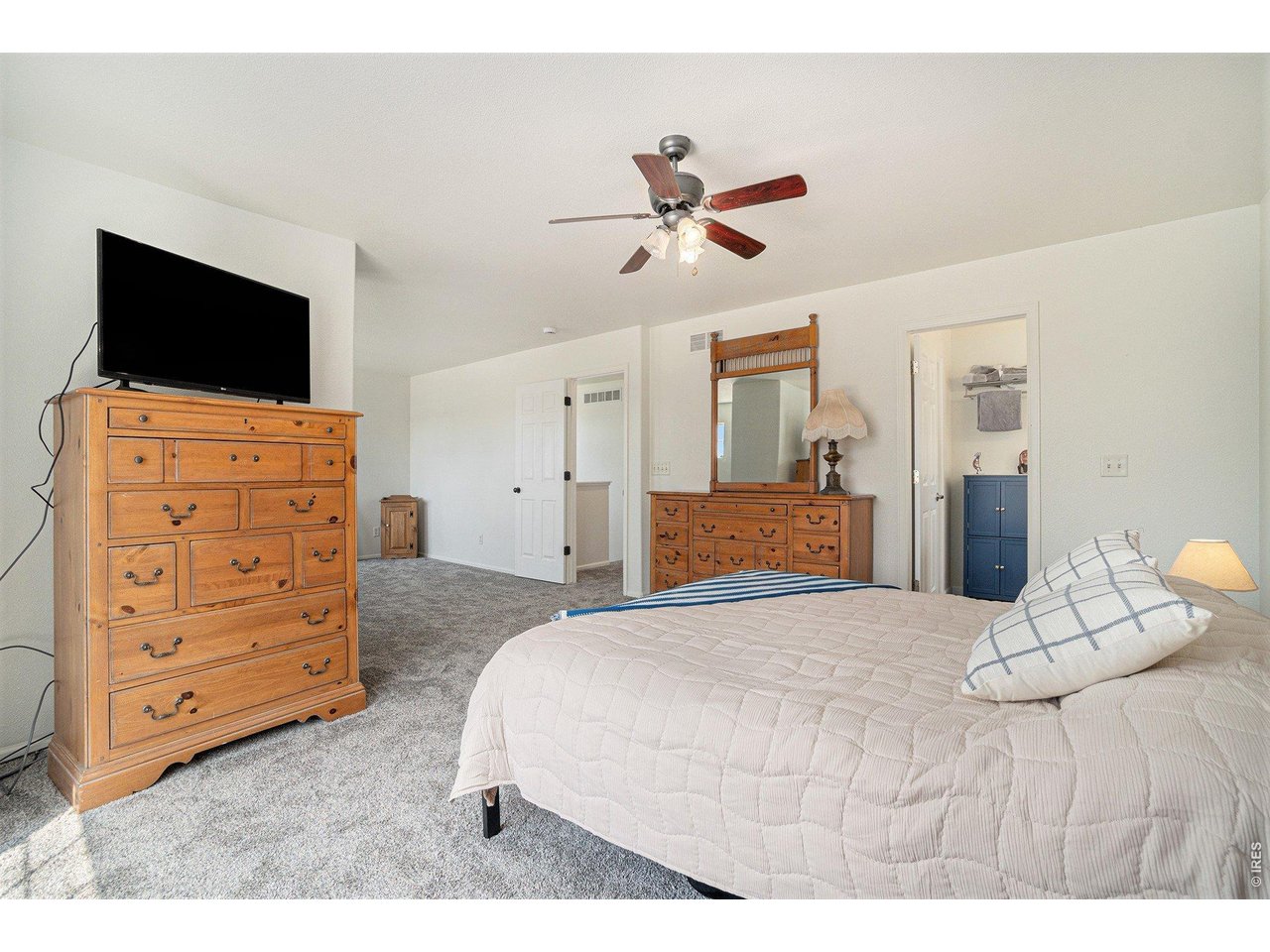 11226 Dover Street Firestone, CO 80504 - Photo 15 of 27 a bedroom with a bed and a flat screen tv
