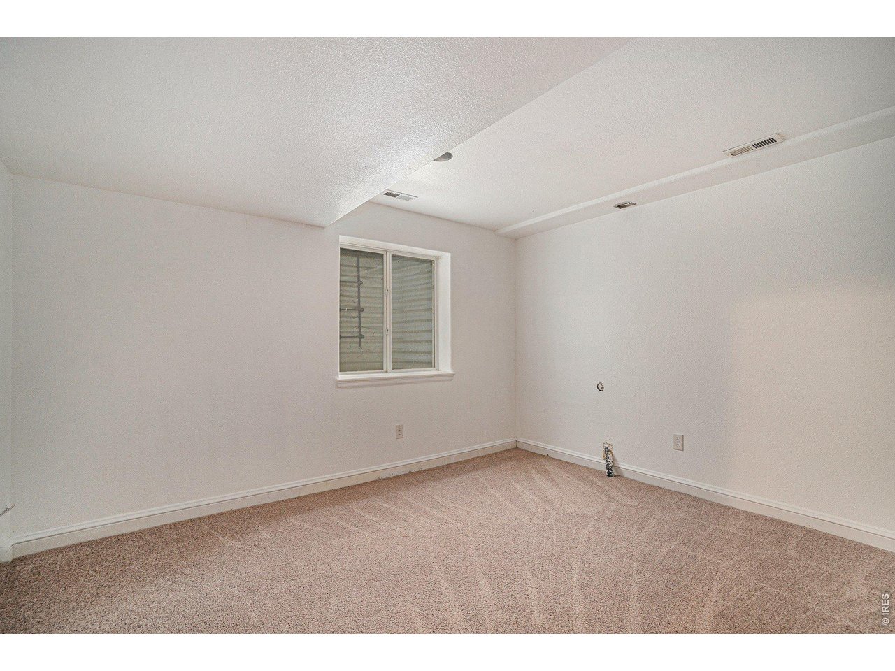11226 Dover Street Firestone, CO 80504 - Photo 18 of 27 an empty room with windows