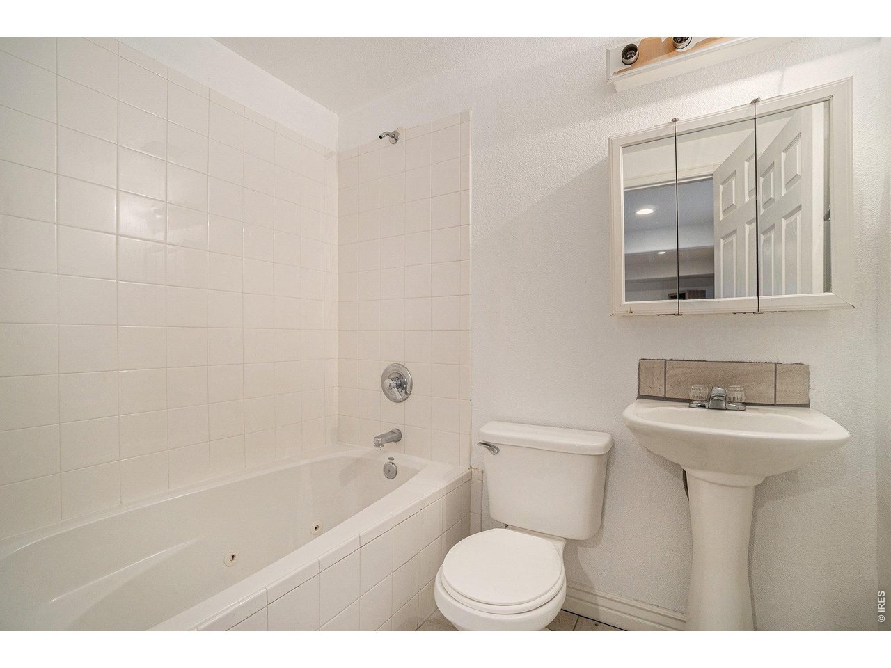 11226 Dover Street Firestone, CO 80504 - Photo 21 of 27 a bathroom with a toilet a sink and bathtub